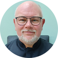 Marc Drake smiling in black glasses in a head and shoulders shot