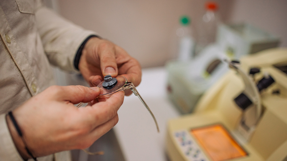 A person manufactures a lens
