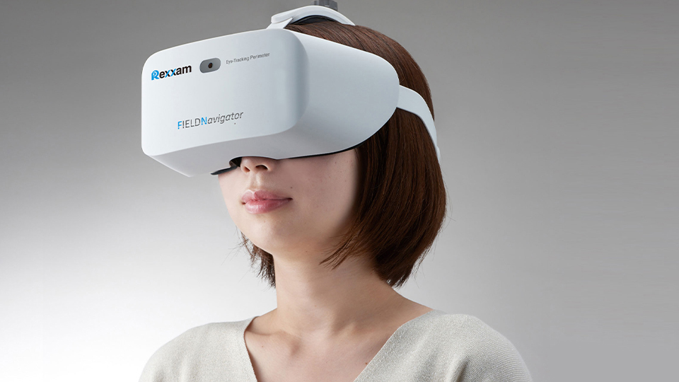 A young woman wears a headset with the branding for Rexxam