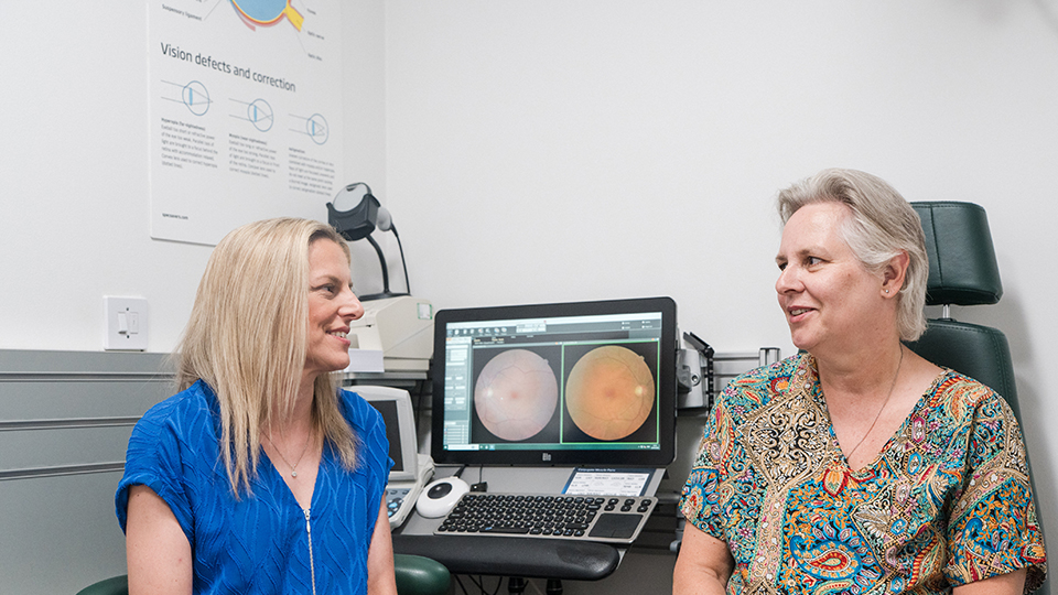 Senior optometrist, Caroline Mosses, speaks with GERS patient, Sarah Peyton