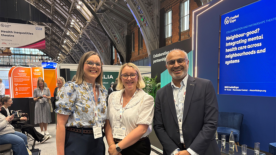 Lucy Miller standing with Dharmesh Patel and Lisa Gibson