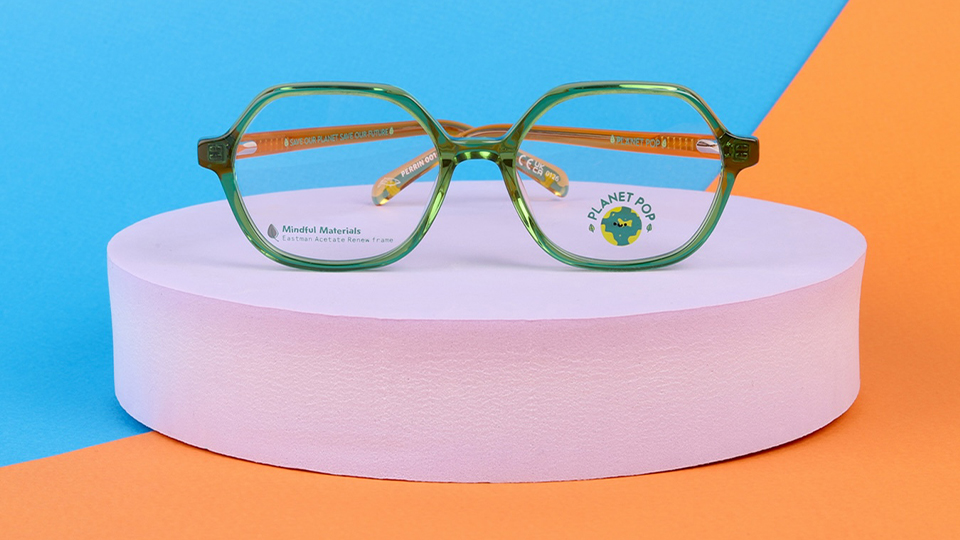 A green frame is balanced on a lavender display circle, the background is split between orange and blue