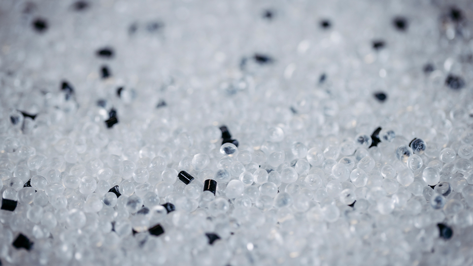 Thousands of clear and black plastic pellets