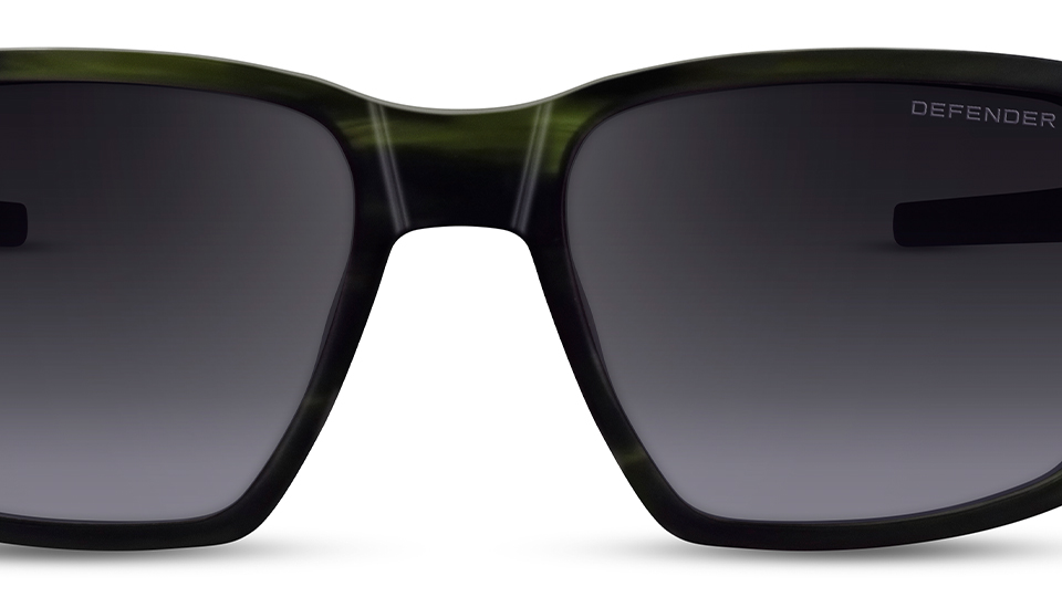 Black rectangle frames from the Defender brand. The frames have a metal square lug in the corners and grey lenses. The brand name is etched onto one of the lenses.