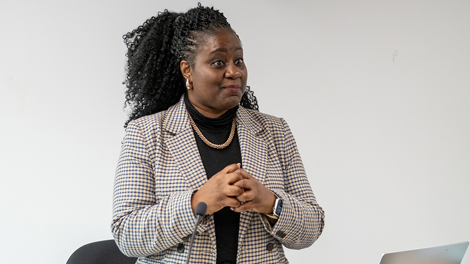 Marsha de Cordova MP standing in front on a podium during the 2025 Women in optometry conference