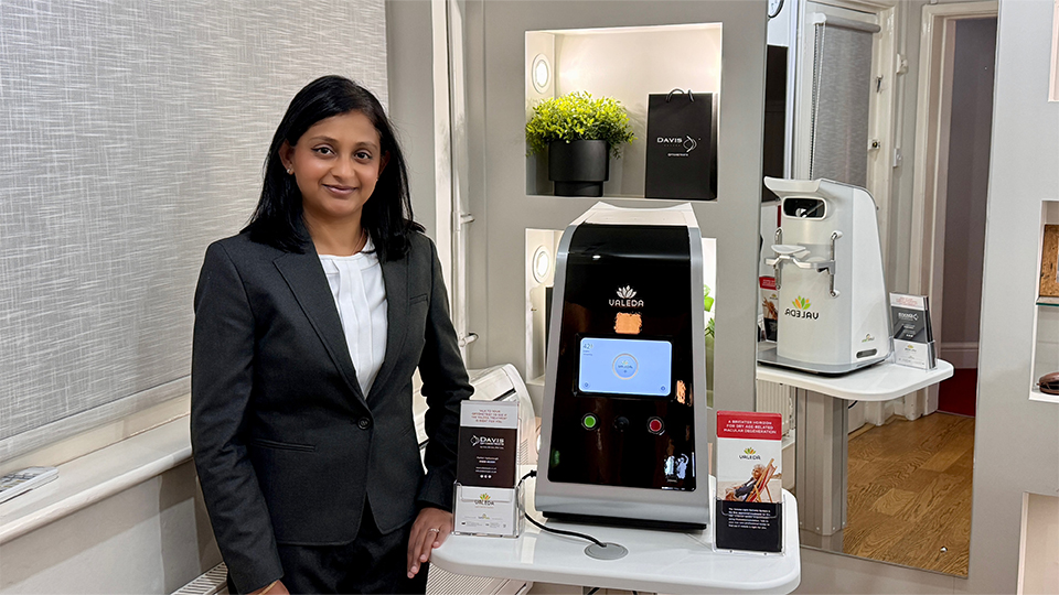 Woman standing in front of Valeda machine in a testing room