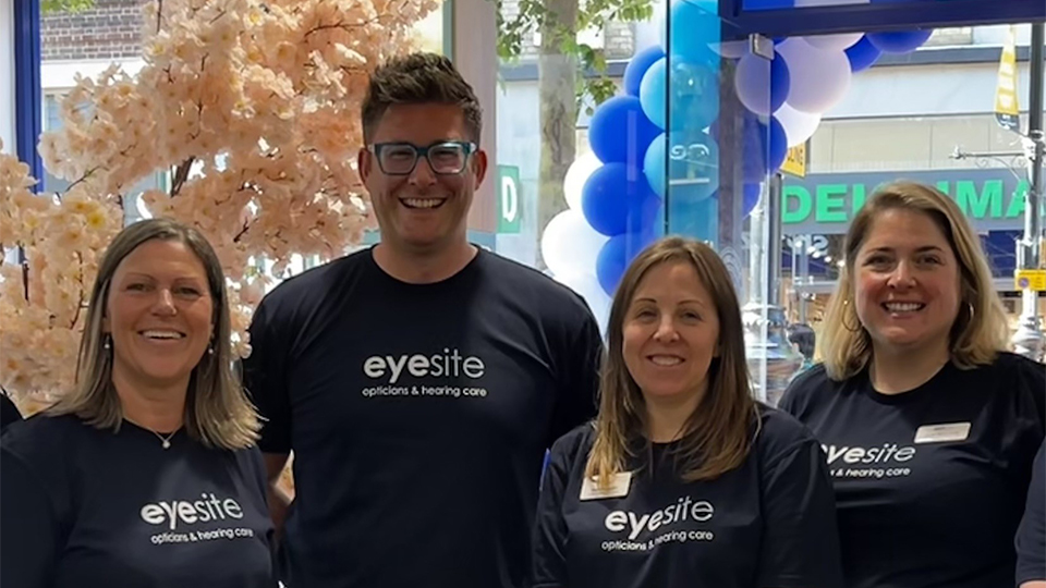A group of four people including Helen on the left are gathered in the practice all wearing Eyesite branded t-shirts