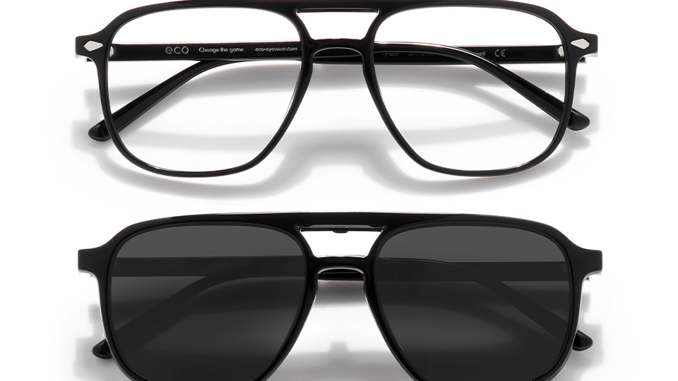 A pair of black aviator style frames with a clip-on sunglasses front