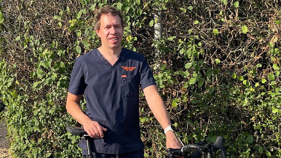 Joel wearing his practice uniform holding his bike
