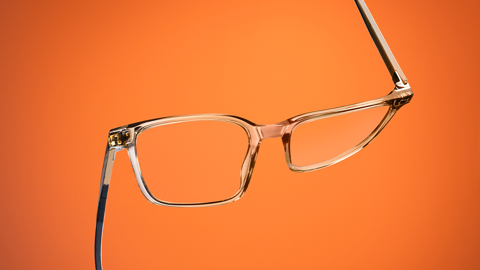 A pair of squared spectacles are twisted, one arm pointing up and one down