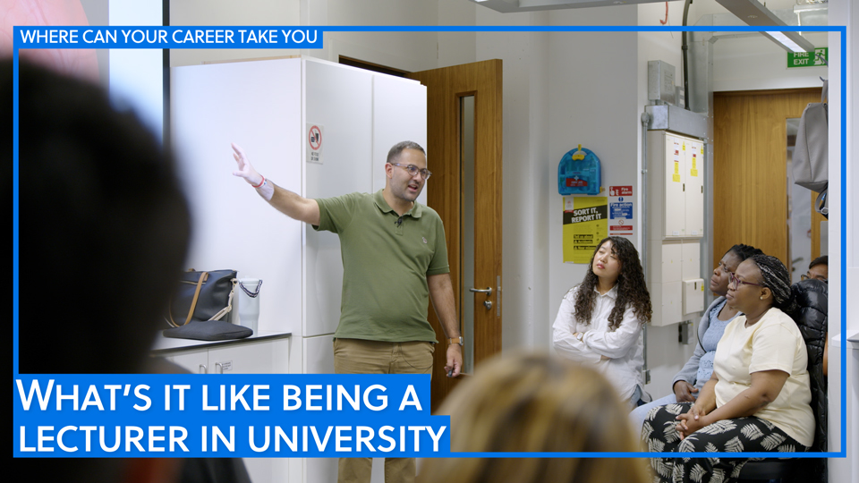 Lecturer pointing into the distance as his students listen