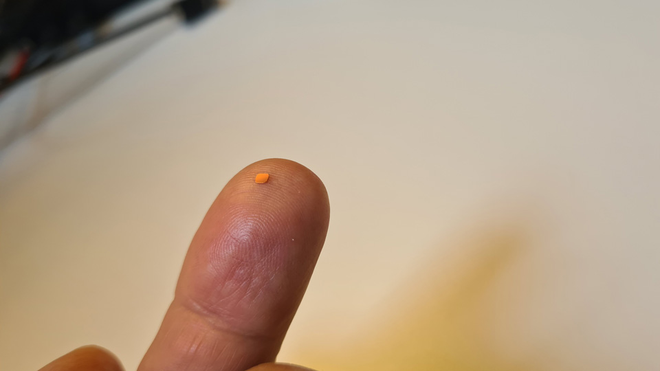 The PRIMA System chip is balanced on a finger, looking tiny