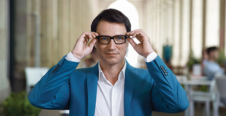Man putting on spectacles