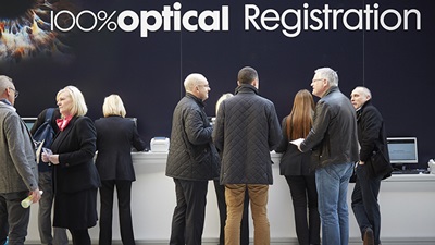 People at the registration desk at 100% Optical 2015