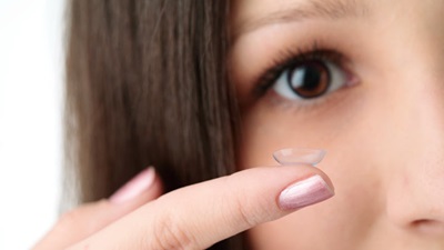 lady putting contact lens in