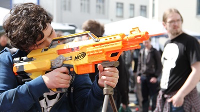 A man holding a Nerf gun