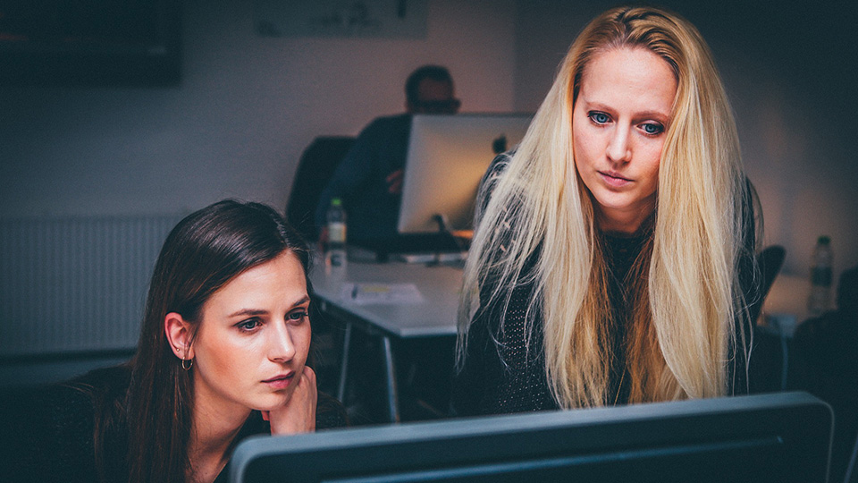 Two women looking at a computer