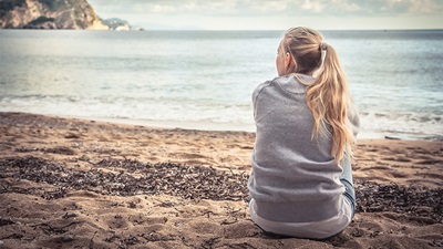 A women sitting on a beach
