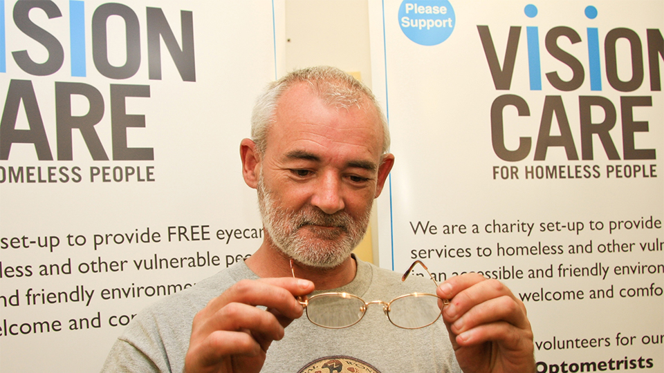 Man looking at glasses