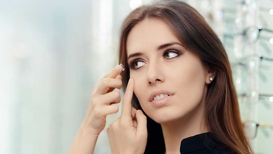 Women putting in a contact lens