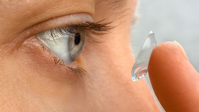 Person inserting a contact lens