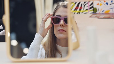 A women trying on eyewear at Mido