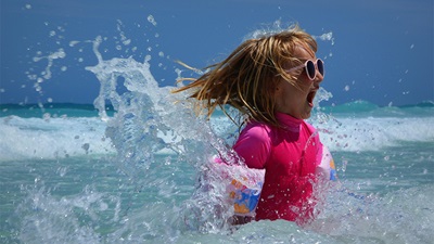 A child in the sea wearing glasses