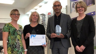 Lunettes Opticians receiving award