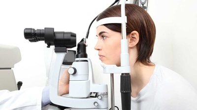 Lady at optometry equipment 