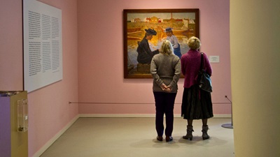 Two women looking at art work