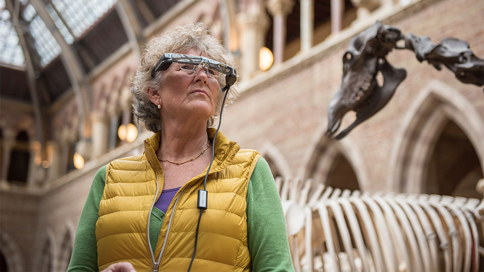 A women wearing OxSight electronic glasses