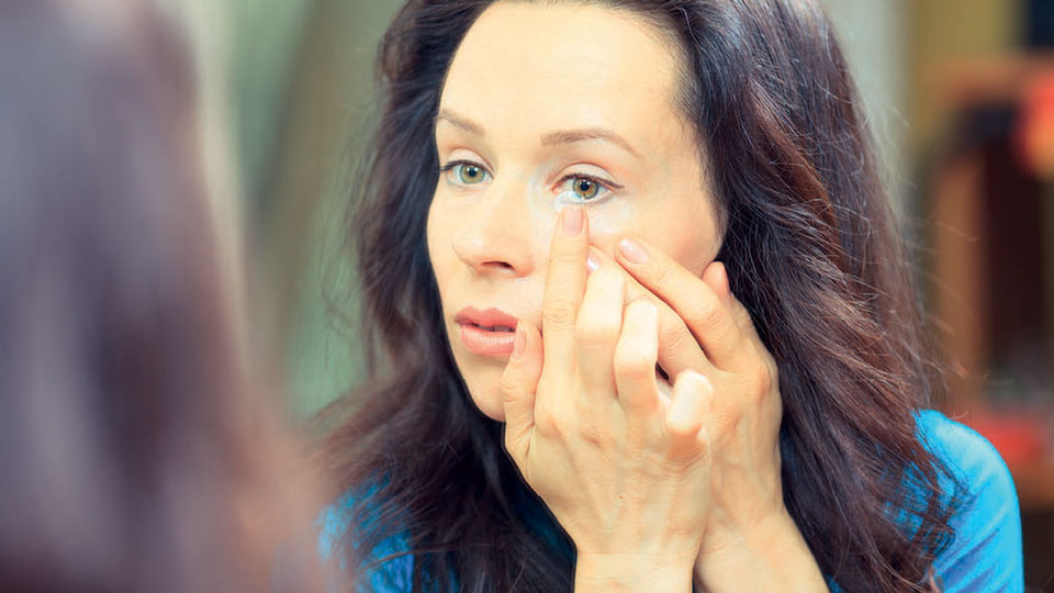 Lady putting in contact lens