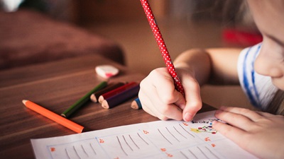 child holding pencil