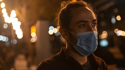 person wearing blue face mask