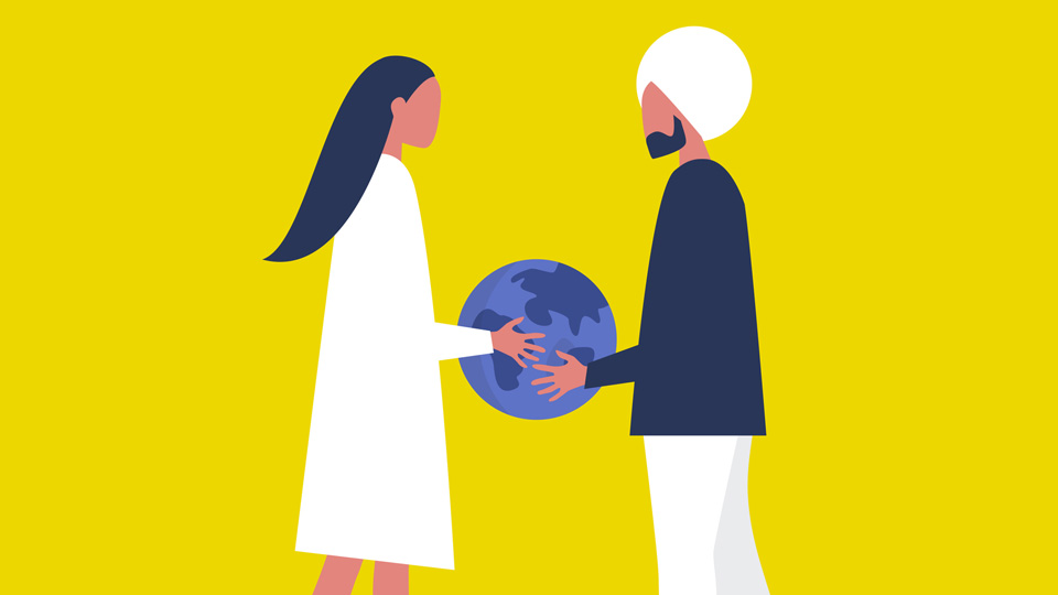 Two people holding a planet
