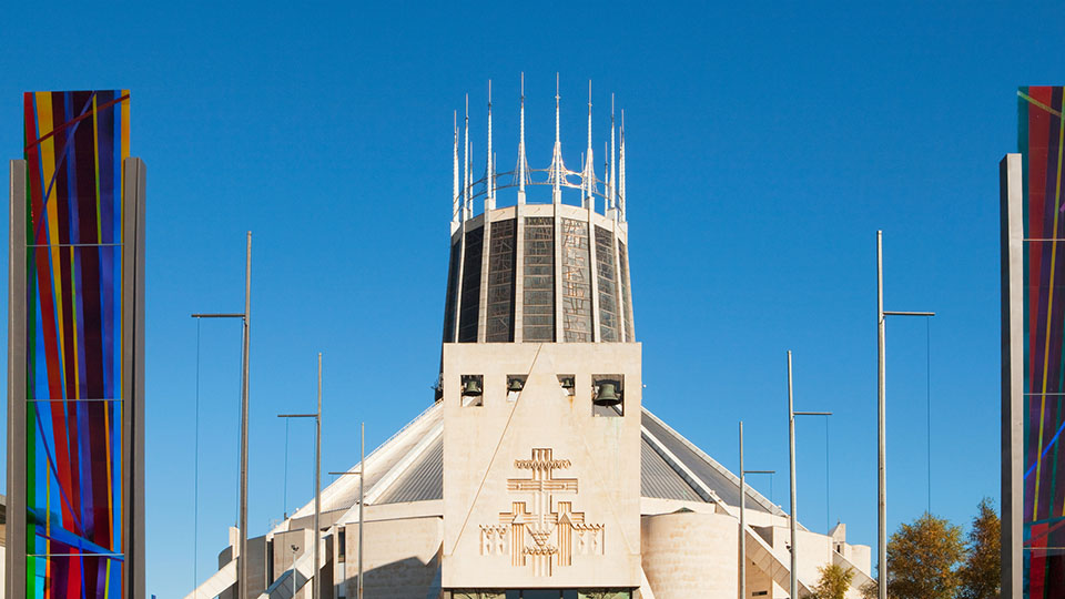 Liverpool Metropolitan Cathedral, in Liverpoool, UK, is seen from the front on a sunny day with blue skies