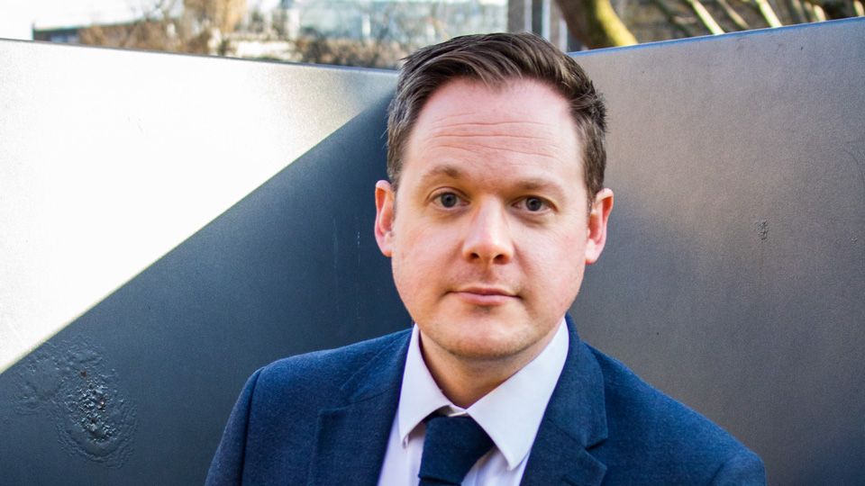 Man in suit looking into the camera