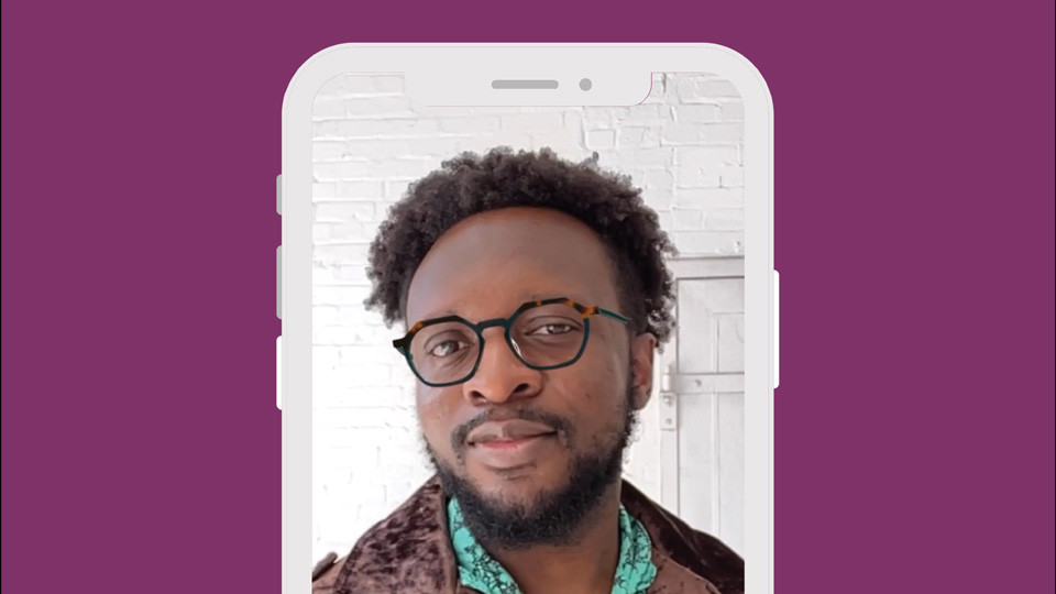 A phone screen shows a person trying on glasses