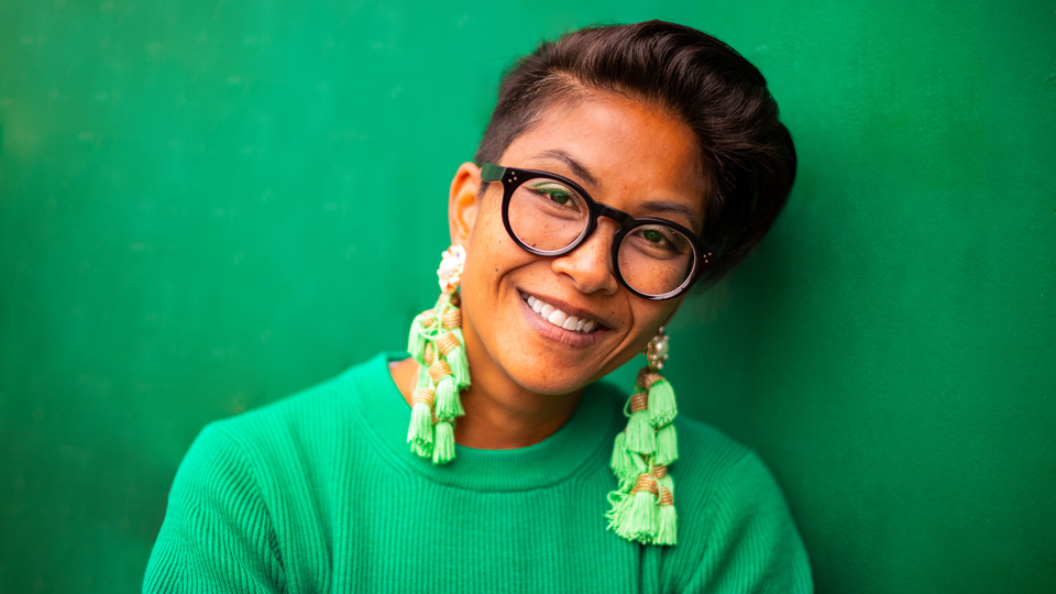 Chantelle wears bright colours and a pair of bold black frames 