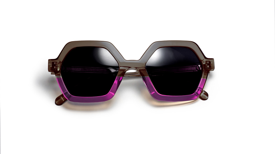 Hexagonal shaped sunglasses with dark lenses, and half-half design of dark crystal acetate and dark pink. 