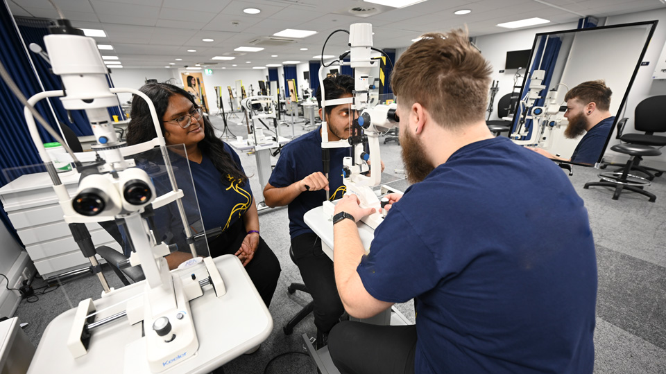 Students use the optometry equipment in the new facilities