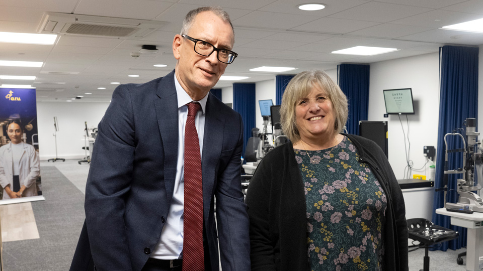 University Eye Clinic service user Penny Barker opening the new centre, with Vice Chancellor Professor Roderick Watkins