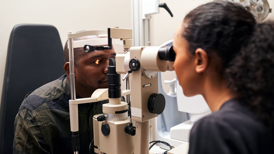 A patient receives a sight test in an optometry practice