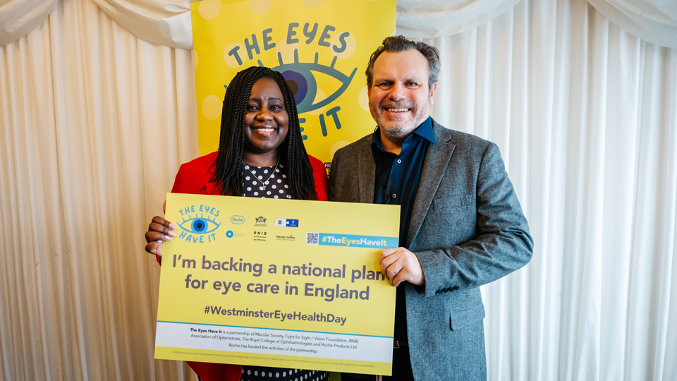 MP Marsha de Cordova, with long braided black hair standing next to Keith Valentine, a man with short brown hair. 
