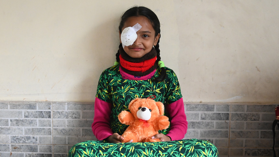 Young girl with an eye patch following a successful cataract operation