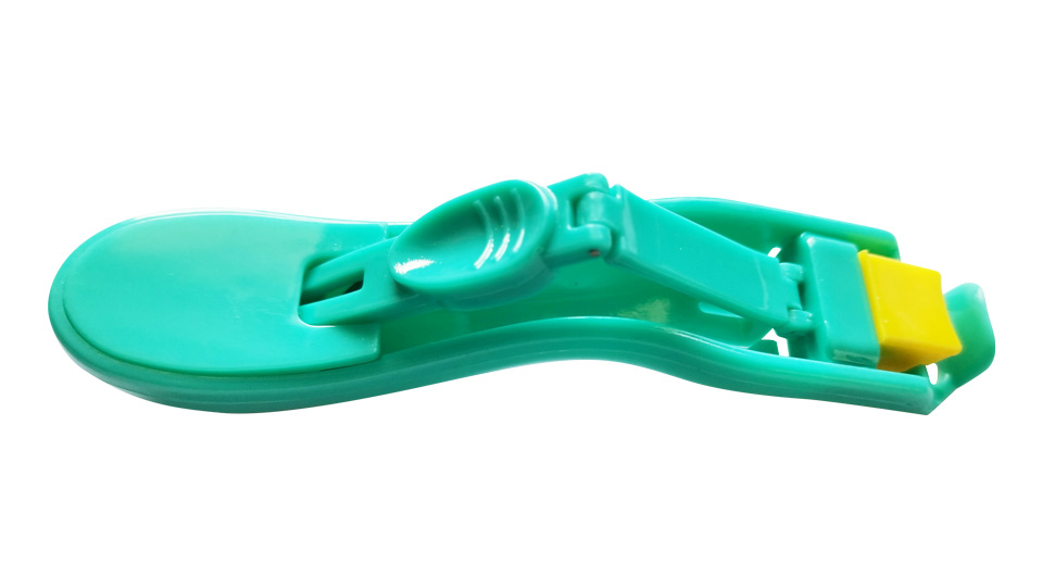 A green plastic plate with soft yellow medical grade rubber head