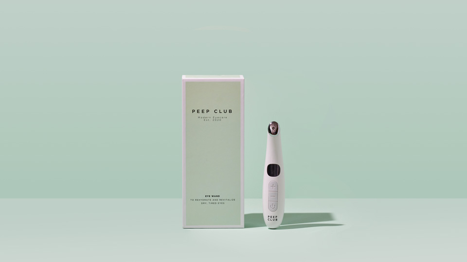 A handheld device and box in mint green and white colours with the Peep Club branding are photographed on a matching mint green background 