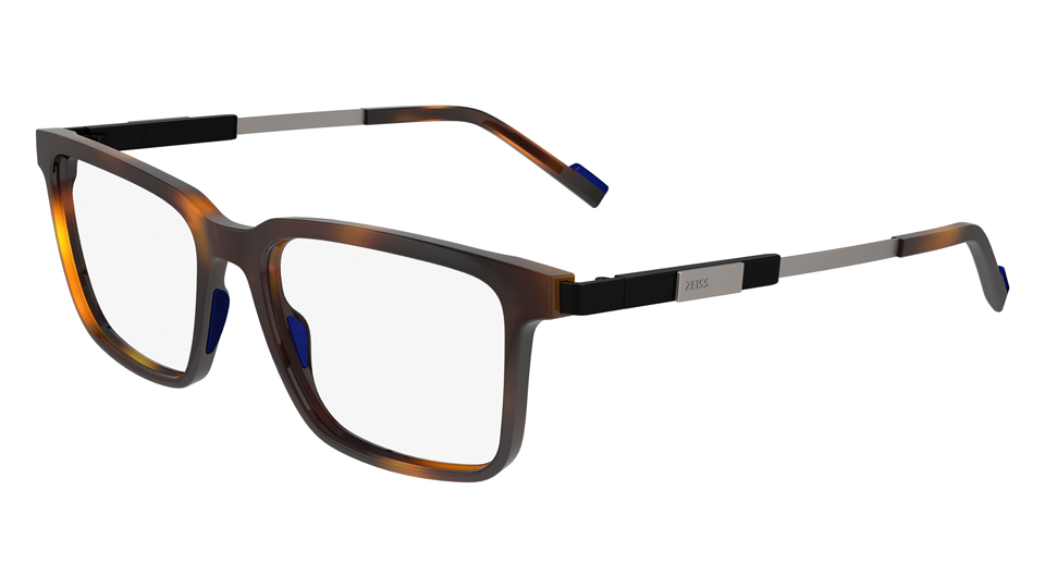 A pair of slim metal and tortoiseshell rectangular spectacles are angled to the left