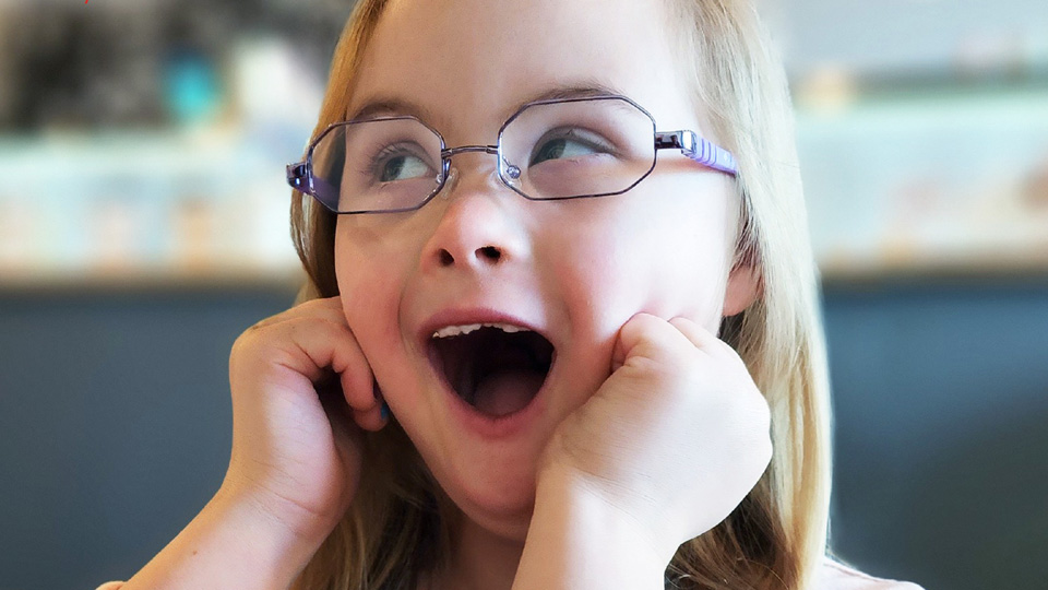  A young girl poses in lavender spectacles 