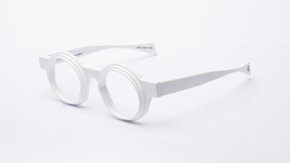 A pair of angular white frames are posed off-centre  